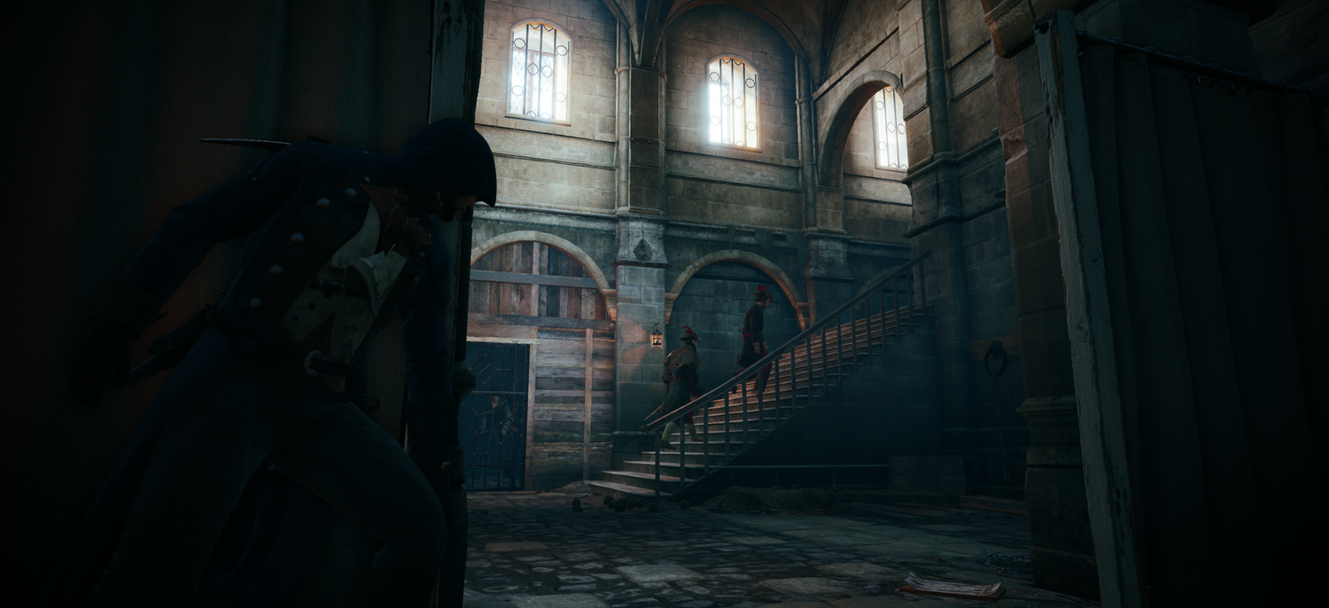 A screenshot of Assassin&rsquo;s Creed Unity &ldquo;Les Enragés&rdquo; mission. An Assassin is hiding in an interior jail cellblock.